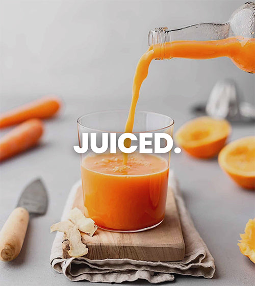 The image shows off a glass being filled with orange juice that was freshly made in a centrifugal juicer