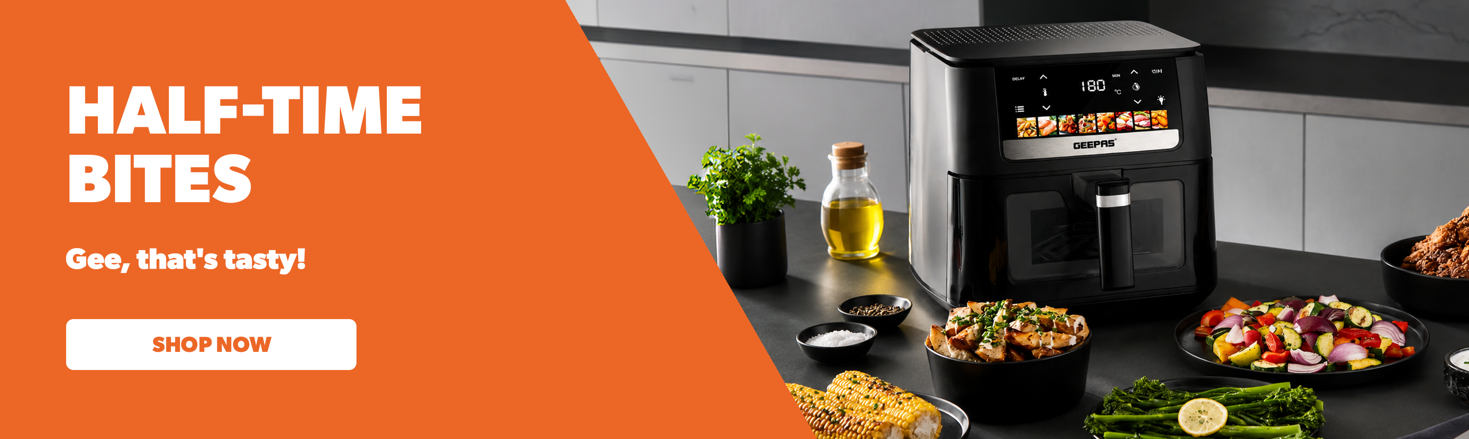 A large digital touchscreen control air fryer on top of a kitchen countertop with multiple air fryer dishes around it.