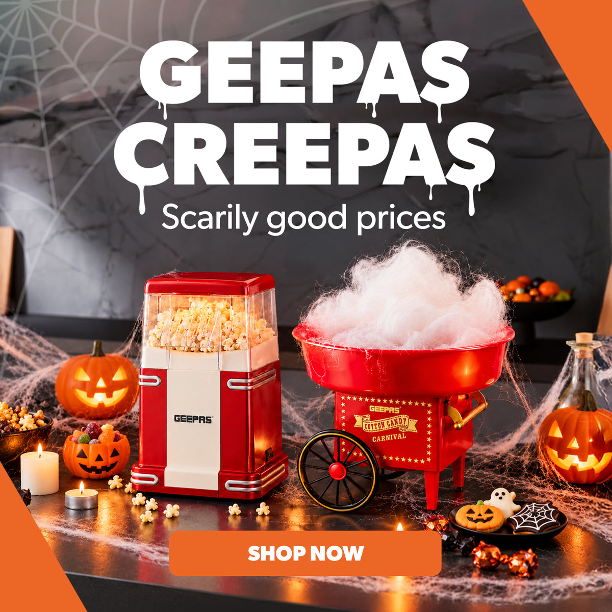 A Halloween-themed promotional graphic for Geepas Creepas, showing a red and cream popcorn machine and a red cotton candy cart on a spooky table with pumpkins, cobwebs, and candles. Large text reads 'GEEPAS CREEPAS' and 'Scarily good prices' with a 'SHOP NOW' button.