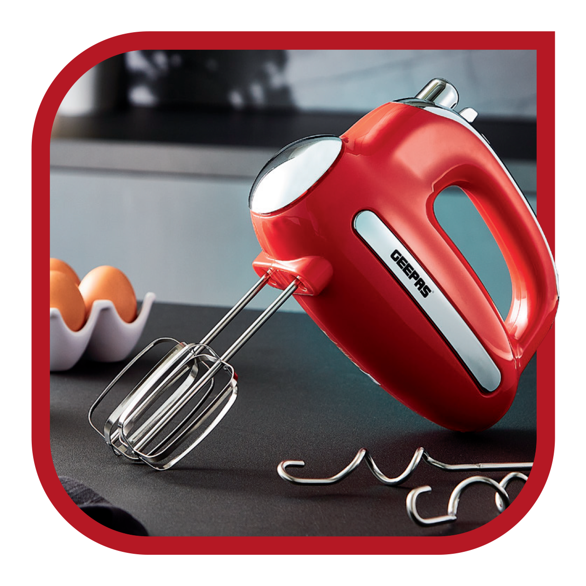 The image shows off a hand mixer on top of a kitchen countertop, the mixer is part of the retrovive collection range.