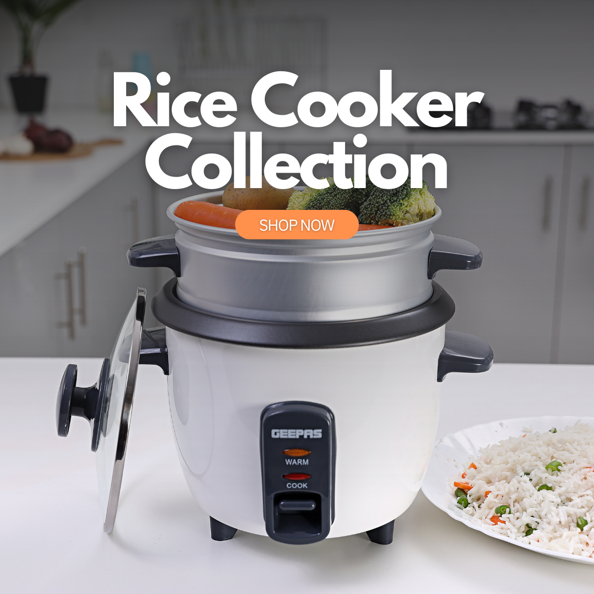 A large model of the rice cooker on top of a kitchen countertop with veg inside ready for steaming and a large plate of rice besides it.
