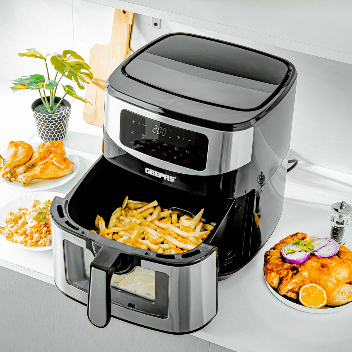 The 9.2L vortex air fryer with different dishes around it on top of a kitchen countertop.
