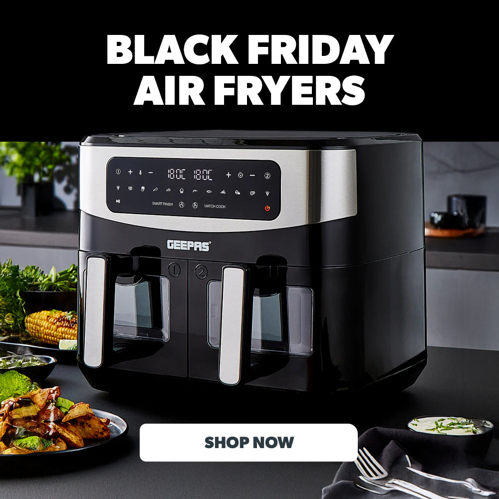 Black Friday air fryer deals with a double basket air fryer on top of a kitchen countertop and several dishes made in the air fryer around it.